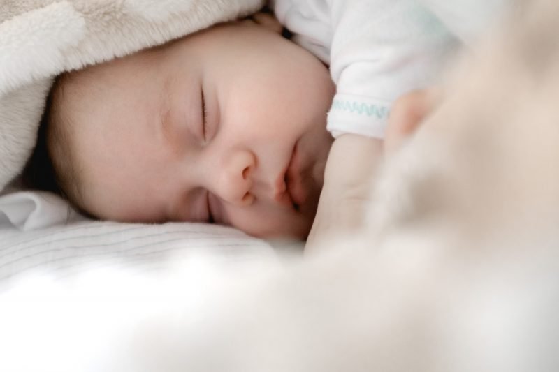 Baby sleeping under a blanket - JoAnna Inks Sleep Solutions